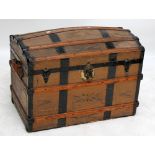 A vintage dome topped strap bound trunk.