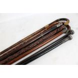 Seven walking sticks and canes with metal mounts,