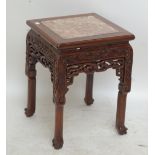 A Chinese carved hardwood jardinière stand with marble top, height 47cm.