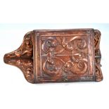 A small Arts and Crafts beaten copper mounted foliate motif corner cupboard with door enclosing