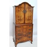 A reproduction burr walnut linen press of small proportions, width 75cm.