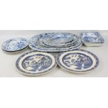 A group of blue and white transfer decorated meat platters, plates and bowls including Wedgwood.