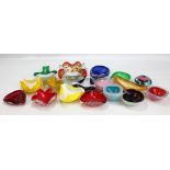 A group of colourful glass shallow bowls, pin dishes and ashtrays.