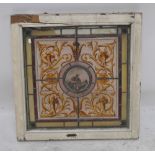 A 19th century stained glass leaded window panel depicting a bird to central circular section