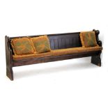 A Victorian pine pew with shaped ends, width 231cm.