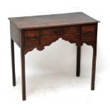 A late George III oak lowboy raised on square sectioned chamfered legs, width 80.5cm.