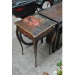 A decorative 20th century square sectioned French occasional table painted to the top with a