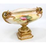 A Royal Worcester blush ivory porcelain oval footed bowl with foliate scroll twin handles,