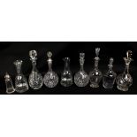 A group of clear glass decanters to include a pair with associated stoppers,