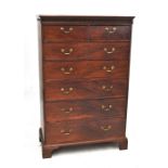 A large early 19th century mahogany chest, the moulded cornice above blind fret frieze,