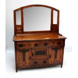 A late Victorian walnut sideboard with associated mirrored back and carved detail to the base,