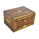 A rosewood travel stationery box with inlaid brass detail and campaign style handles,