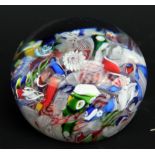 A Baccarat clear glass scrambled latticino and millefiori decorated paperweight, diameter 4.5cm.