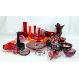 A large quantity of pale pink, purple, orange and red tinted glass including shallow bowls, vases,