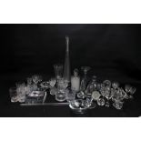 A collection of clear glass including tall vase, candle holder, ashtrays, drinking glasses, etc.