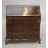 A reproduction walnut breakfront bureau, with fall front above four long drawers,