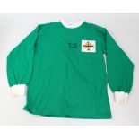 GEORGE BEST; a signed replica retro style Northern Ireland shirt, further inscribed 'Best Wishes'.