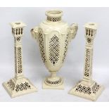 A Leeds pottery three piece garniture comprising a footed ovoid reticulated vase with ram head