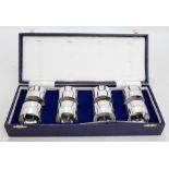 A cased set of eight Elizabeth II hallmarked silver circular napkin rings of plain form with