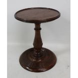 A 19th century mahogany candle stand with turned column and base, height 19cm.