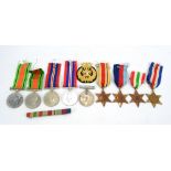 A group of nine WWII medals, a medal box inscribed 'Mr F W Waltes' and a cap badge.