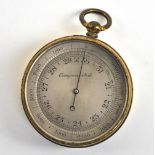 An aneroid pocket barometer with silvered dial inscribed 'Compensated' and with later protective