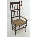 A 19th century ash and elm rush seated elbow chair with turned upper section.