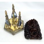 A carved Thai wall mask and a decorative Eastern sprinkler bottle set (2).