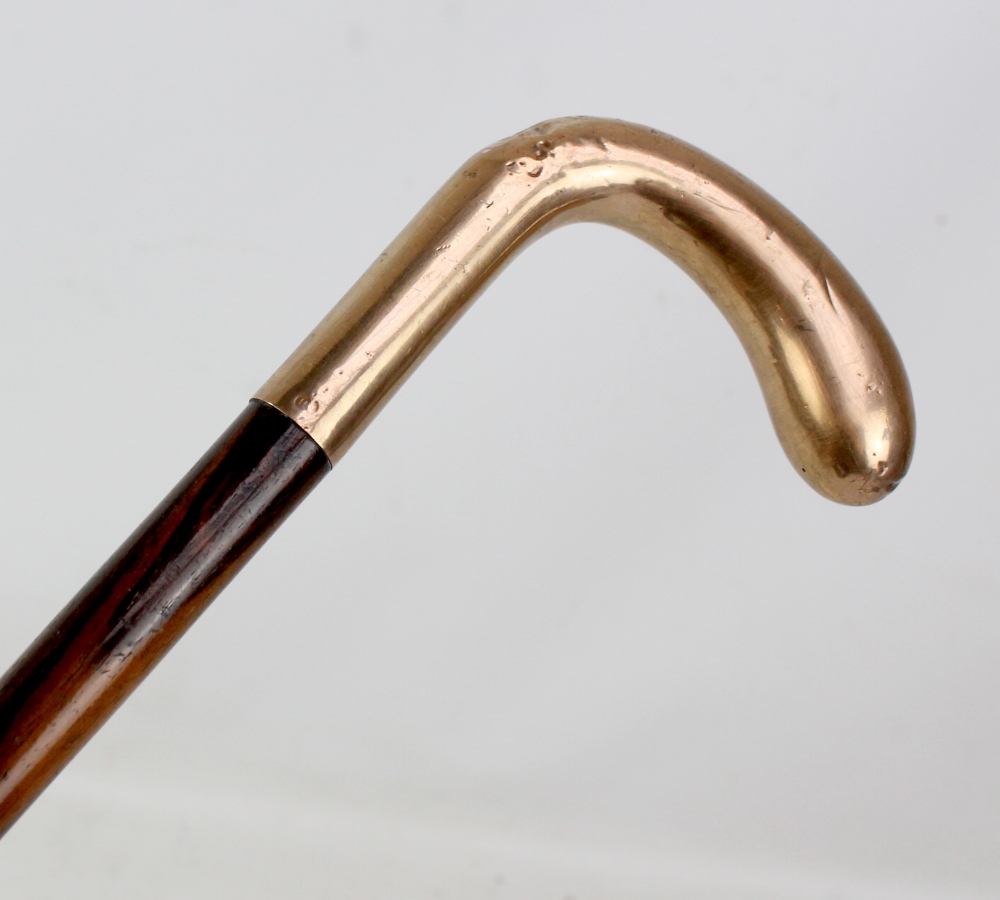 A 9ct yellow gold mounted rosewood walking cane, length 77cm.