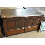 A Georgian oak coffer with hinged lid above full panel front and two drawers, width 143cm.