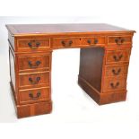 A reproduction yew wood pedestal desk and a matching filing cabinet (2).