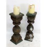 A pair of rustic pine candle stands, height of each approx 75cm.