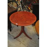 A mahogany tripod occasional table with engraved leatherette top, diameter 69cm.