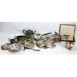 A small group of electroplated items to include a three piece tea set and an entree dish.