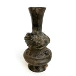 A pre-Colombian 'frog vase' with black ground and decorated with a band of stylised birds beneath