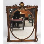 A rectangular gilt framed mirror with acanthus leaf decoration and central oval section,