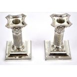 A pair of Victorian hallmarked silver wrythen twist Corinthian column candlesticks with bead