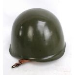 A US green painted helmet with leather lining and chin strap.