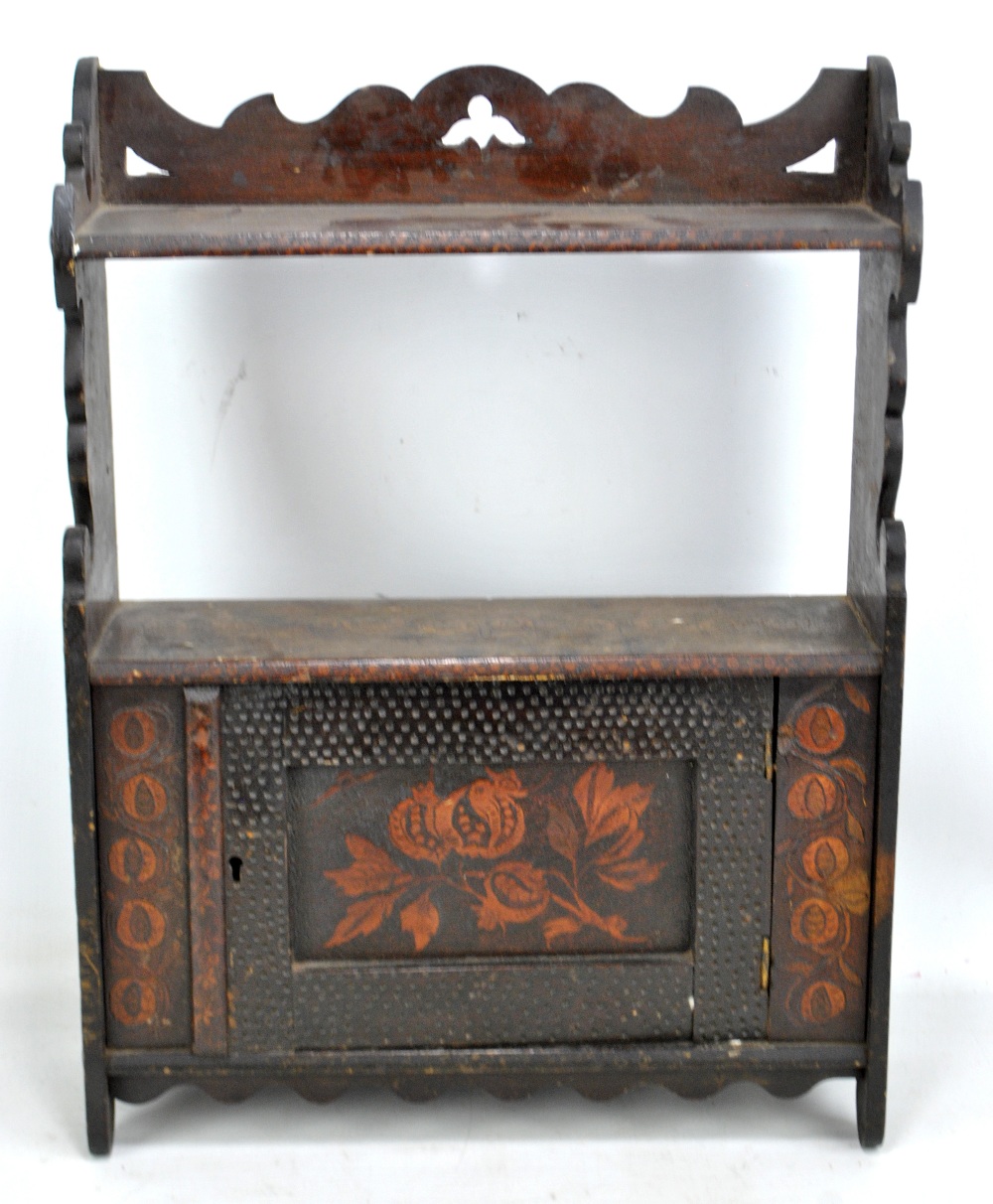 A tabletop cabinet with door to centre and carved foliate detail throughout, 54 x 40cm.