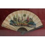 An early 20th century paper transfer decorated and hand coloured fan decorated with figural scene