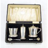 A cased George VI hallmarked silver Art Deco cruet set, comprising a mustard, pepper pot,