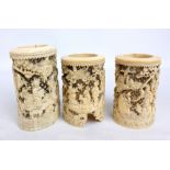 A pair of 19th century Chinese Canton carved ivory cylindrical vases elaborately decorated with