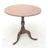 An oak tripod table, diameter 77cm.