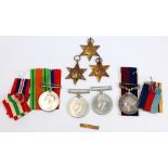A group of WWII medals to include the Africa and Italy Stars with ribbons and original boxes,