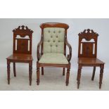 A Victorian mahogany elbow chair with scrolled supports,