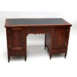 An Edwards & Sons of Newcastle kneehole desk with inset gilt tooled blue leather top above single