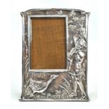 An early 20th century electroplated photo frame embossed with 'Tom, Tom, the Piper's Son' scene,