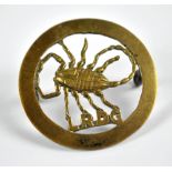 A brass Long Range Desert Group cap badge with two lugs to reverse, diameter 3.2cm.
