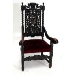 A Victorian carved oak elbow chair with detailed pierced back, swept arms,