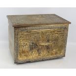 A brass clad box with embossed figural decoration, width 47cm.